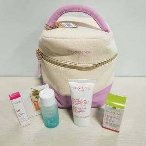 8 X BRAND NEW CLARINS PARIS GIFT SETS CONTAINING TREATMENT OIL, EYE MAKEUP REMOVER, LIP OIL AND BODY LOTION