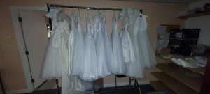 ENTIRE CONTENTS OF STORAGE ROOM TO CONTAIN - 12 X COMMUNION DRESSES IN WHITE - CLOTHING RAIL - LARGE AMOUNT OF SEWING THREAD - LARGE AMOUNT OF RIBBON - WEDDING BOWS - VARIOUS WEDDING FABRICS - GLUE - HEADBANDS - STRAPS AND BUTTONS - PLASTIC CONTAINERS ETC