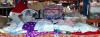 FULL 2 SHELFS BRAND NEW MIXED LOT CONTAINING DRESSED DOLLS IN VARIOUS SIZES - VARIOUS KNITTED BABY CLOTHING - WOOL IN VARIOUS COLOURS AND SIZES - VARIOUS BAGS - BASKET - BLANKETS - WOODEN BABY ROCKER ETC (SEE BOTH IMAGES)