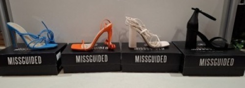 20 X BRAND NEW PAIRS OF ASSORTED MISSGUIDED WOMENS SHOES CONTAINING BLOCK HEEL TIE UP SANDALS IN CREAM , SQUARE TOE TIE UP HEELED SANDALS IN ORANGE , WIDE FIT HIGH HEEL BLOCK BARELY THERE IN BLACK , STRAPPY RING DETAIL HEELED SANDAL IN BLUE ETC ALL IN SI