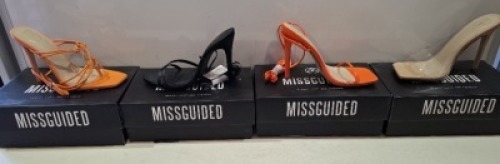 20 X BRAND NEW PAIRS OF ASSORTED MISSGUIDED WOMENS SHOES CONTAINING SQUARE TOE PERSPEX HIGH HEEL MULES IN SAND , SQUARE TOE TIE UP HEELED SANDALS IN ORANGE , POINTED TOE LACE UP BARELY THERE SATIN IN BLACK , STRAPPY RING DETAIL HEELED SANDAL IN ORANGE ETC