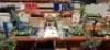 50 X PIECE MIXED PREMIER SUMMER DECORATIONS LOT TO INCLUDE VARIOUS ARTIFICIAL FLOWERS - VARIOUS CACTI - LED BULBS - WATERING CAN - CUSHIONS - WOODEN TABLE - HANGING BASKET - BIRD ORNAMANT - BUTTERFLYS ETC ON FULL BAY