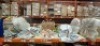 25 X MIXED METAL WIND SPINNERS IN VARIOUS STYLES AND COLOURS IE BRONZE , MULTICOLOURED , BROWN AND BLUE , 1 SOLAR POWERED CHANDELIER LIGHT ON A FULL BAY