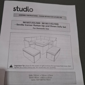 1 X STUDIO SEVILLE CORNER RATTAN UP AND DOWN SOFA SET LOT CONTAINING SOFA SIZE 192 X 192 X 79CM AND STOOLS IN SIZE 40 X 80 X 42 CM AND TABLE IN SIZE 100 X100 X50/70CM IN BLACK / GREY IN TWO BOXES (NOTE CUSTOMER RETURNS )