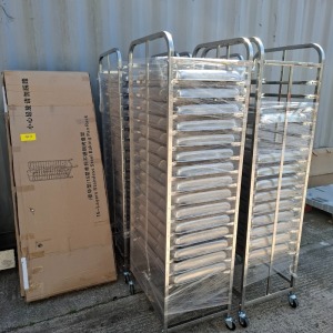 6 X ALUMINIUM / STAINLESS STEEL FOOD / BAKING RACKS / TROLLIES IE. 4 X ASSMEBLED TROLLIES 53 X STAINLESS STEEL TRAYS 2 X BRAND NEW TROLLIES