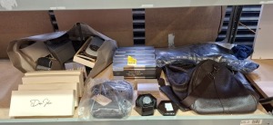 40+ MIXED DAN JOHN CLOTHING LOT CONTAINING DARK BROWN BAG , ANTI SLIP HEEL SOCKS , DAN JOHN WATCH IN BLACK , SOCKS IN GREY,BLACK AND NAVY IN ALL SIZES , TROUSER IN DARK BLUE IN SIZE 60 ETC ON HALF A BAY
