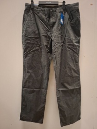 40 X BRAND NEW MIXED CLOTHING LOT CONTAINING UNDER ARMOUR POLO TOP IN WHITE IN SIZE XS , COLUMBIA PANTS IN GRAPHITE ALL IN SIZE 38 IN TWO TRAYS (NOTE TRAYS NOT INCLUDED)