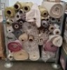 APPROXIMATELY 50 PART ROLLS OF FABRIC IN VARIOUS SIZES AND COLOURS AND STYLES IN A FULL METAL CRATE ( STILLAGE NOT INCLUDED)