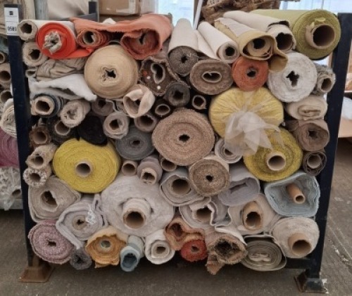 APPROXIMATELY 50 PART ROLLS OF FABRIC IN VARIOUS SIZES AND COLOURS AND STYLES IN A FULL METAL CRATE ( STILLAGE NOT INCLUDED)