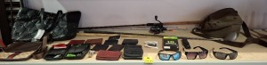 21 X MIXED LOT CONTAINING FISHING ROD , MENS WALLETS IN VARIOUS COLOURS , SUNGLASSES , FIRE HARROWS DARTS SET IN BAG , LADIES BLACK BAG ETC ON 3/4 OF A SHELF