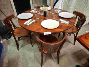 1 X MIXED DINING LOT TO INCLUDE 1 X ROUND WOODEN TABLE 4 X WOODEN CHAIRS - 4 X PLATES - 4 X WINE GLASSES - 2 X VASES - CANDLE - CUTLERY ETC
