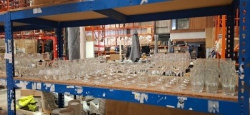 LARGE AMOUNT OF GLASSES TO INCLUDE WINE GLASSES IN VARIOUS STYLES - COCKTAIL GLASSES - BEER GLASSES - SHOT GLASSES ETC