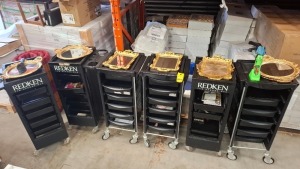 6 X REDKEN 5TH AVENUE NYC SALON TROLLEYS IN BLACK WITH ACCESSORIES, BARBERS CLIPPERS , GOLD COLOURED MIRROR TRAYS , HAIRBRUSHES , LUXURY FAKE EYELASHES ETC