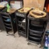 6 X REDKEN 5TH AVENUE NYC SALON TROLLEYS IN BLACK WITH ACCESSORIES, BARBERS CLIPPERS , GOLD COLOURED MIRROR TRAYS , HAIRBRUSHES , LUXURY FAKE EYELASHES ETC - 3