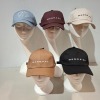 60 X BRAND NEW MENNACE LOGO BASEBALL CAPS IN VARIOUS COLOURS BLUE , BROWN , BLACK , OFF WHITE AND MAUVE IN TWO TRAYS