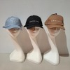 60 X BRAND NEW MENNACE LOGO BASEBALL CAPS IN VARIOUS COLOURS BLUE , BROWN , BLACK , AND MAUVE IN TWO TRAYS
