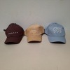 60 X BRAND NEW MENNACE LOGO BASEBALL CAPS IN VARIOUS COLOURS BLUE , BROWN , BLACK , OFF WHITE AND MAUVE IN TWO TRAYS - 2