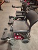 2 X FREERIDER LUGGIE FOLDING POWER WHEELCHAIRS IN BLACK / RED (PLEASE NOTE WE ARE UNABLE TO GET THEM TO START / SPARE OR REPAIR ) OVER ALL CONDITION GOOD ( SEE ALL IMAGES FOR CONDITION ) - 2