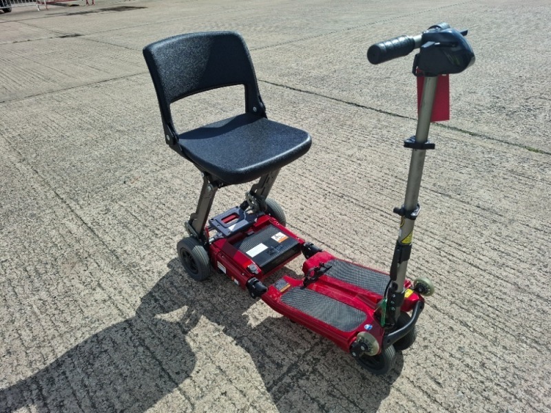 LUGGIE FOLDING MOBILITY SCOOTER IN RED NO CHARGER - TESTED WORKING WITH CHARGE REMAINING IN BATTERY CONDITION GOOD ( SEE ALL IMAGES FOR CONDITION )