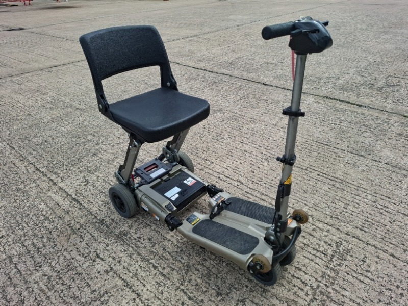 LUGGIE FOLDING MOBILITY SCOOTER IN GREY TAUPE NO CHARGER - TESTED WORKING WITH CHARGE REMAINING IN BATTERY CONDITION GOOD ( SEE ALL IMAGES FOR CONDITION )