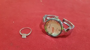 2 PIECE ASSORTED LOT CONTAINING 1 X WATCH BRANDED RAMELIA AND 1 X SILVER COLOURED RING WITH CLEAR STONE.