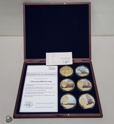 WINDSOR MINT SET OF 6 COMMEMORATIVE COINS, EACH 54G CU GOLD PLATED WITH PAD PRINT. 250TH ANNIVERSARY OF HMS VICTORY, TOGETHER WITH CERTIFICATE OF OWNERSHIP NO. Z000492 AND CERTIFICATE OF AUTHENTICITY, CONTAINED IN A ROSEWOOD PRESENTATION CASE