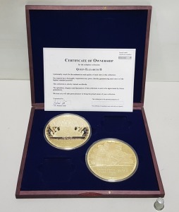 2 OFF WINDSOR MINT LARGE GOLD PLATED COMMEMORATIVE COINS, HEAD OF THE HOUSE OF WINDSOR - HM QUEEN ELIZABETH 2 & 'CORONATION OF HM QUEEN ELIZABETH 2 - 1953'. TOGETHER WITH CERTIFICATE OF OWNERSHIP No. 001332 CONTAINED IN A DARK WOOD PRESENTATION CASE