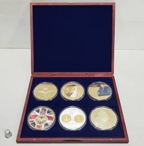 SET OF 6 LARGE COMMEMORATIVE COINS, COPPER GOLD PLATED, CONTAINED WITHIN A ROSEWOOD COLOURED WOODEN PRESENTATIONS CASE