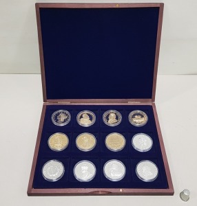 SET OF 12 VARIOUS COMMEMORATIVE COINS CONTAINED WITHIN A ROSEWOOD COLOURED WOODEN PRESENTATION CASE