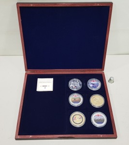 SET OF 6 VARIOUS COMMEMORATIVE COINS, COPPER SILVER PLATED WITH SPOT GOLD, CONTAINED WITHIN A ROSEWOOD COLOURED WOODEN PRESENTATION CASE