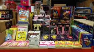 LARGE SELECTION OF GIFTSHOP ITEMS ON HALF A SHELF IE. POCKET SHOCK-IT, HETTY DESK VACUUM, VOODOO DOLLS, UNIVERSITY CHALLENGE THE UNOFFICIAL STUDENT GUIDE, GIRLS NIGHT COCKTAIL BOOKS, I AM CARD & DICE GAMES, SUPER SIZE ME GLASS, BUILD YOUR OWN BATTLE TOPS,