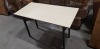 4 X BOXED OAK COLOURED FOLDABLE RECTANGULAR TABLES 60CM X 120CM (SOME MINOR SCUFFING)