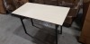 4 X BOXED OAK COLOURED FOLDABLE RECTANGULAR TABLES 60CM X 120CM (SOME MINOR SCUFFING)