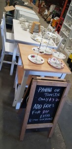 WHITE DINING TABLE WITH 4 CHAIRS, BREAKFAST TABLE WITH 2 CHAIRS AND APPROX 60 PCS OF PORCELAIN CROCKERY & AN ADVERTISING CHALK BOARD (DOUBLE SIDED)