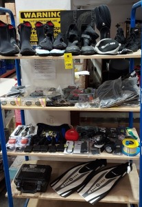 4 X FULL SHELVES OF SCUBA EQUIPMENT I.E SCUBA SHOES, AQUA LUNG FINS, WATERPROOF LED LIGHTS, MAX WAX AND T-SHIRTS ETC