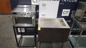 2 PIECE CATERING LOT CONTAINING SAMSUNG (CM1919) 1800W MICROWAVE OVEN ON A PORTABLE STAND PLUS 1 X DEEP FRY COOKED CHIPS DISPENSING STAND ON WHEELS