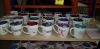 150 + PIECE BRAND NEW MUGS LOT CONTAINING LARGE AMOUNT OF OUTDOOR MUGS ( VARIOUS NAMES ) AND COLOURS , LARGE AMOUNT BRU CUPS IN VARIOUS STYLES AND COLOURS - GOOD TREAT CUPS ( VARIOUS NAMES AND COLOURS ) ETC - ON 5 SHELVES - 3