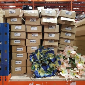 40 BRAND NEW BOXES FULL OF VARIOUS POLYESTER ARTIFICIAL FLOWERS to INCLUDE CANDLE RINGS IN BURGUNDY / CREAM RUST / WINE RED/ MAUVE COMBO / PEACH GREEN AND LILAC SPRAY IN BURGUNDY AND MAUVE