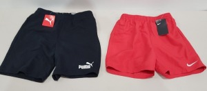 12 X BRAND NEW MIXED SHORTS SHORTS LOT CONTAINING 7 X PUMA SWEAT SHORTS REGULAR FIT IN BLACK - ALL IN SIZE 13 / 14 YRS 5 X NIKE SHORTS WITH MESH BRIEFS IN RED - ALL IN SIZE KIDS XL