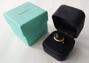 GENTS SILVER COLOURED & BLACK STONE SIGNET RING WITH BLACK DISPLAY BOX & RETAIL BOX PRINTED TIFFANY & CO. RING IS STAMPED AS FOLLOWS - TIFFANY & CO - (SIGNATURE) - AG925 - HONG KONG NOTE: RING SIZE - 18mm DIA